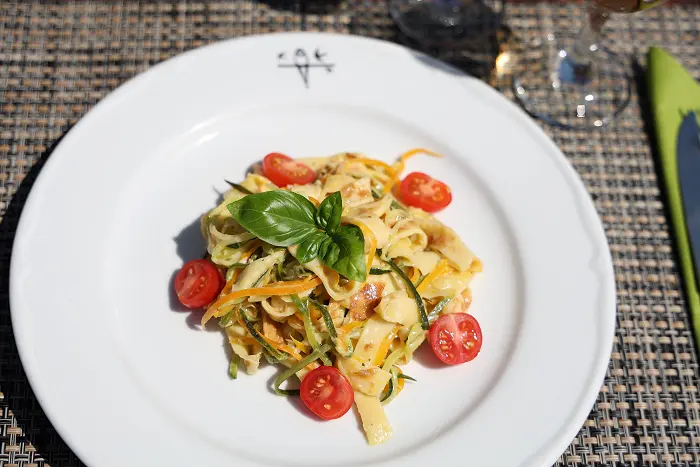 Homemade tagliatelle with zucchini, carrots, and cherry tomatoes